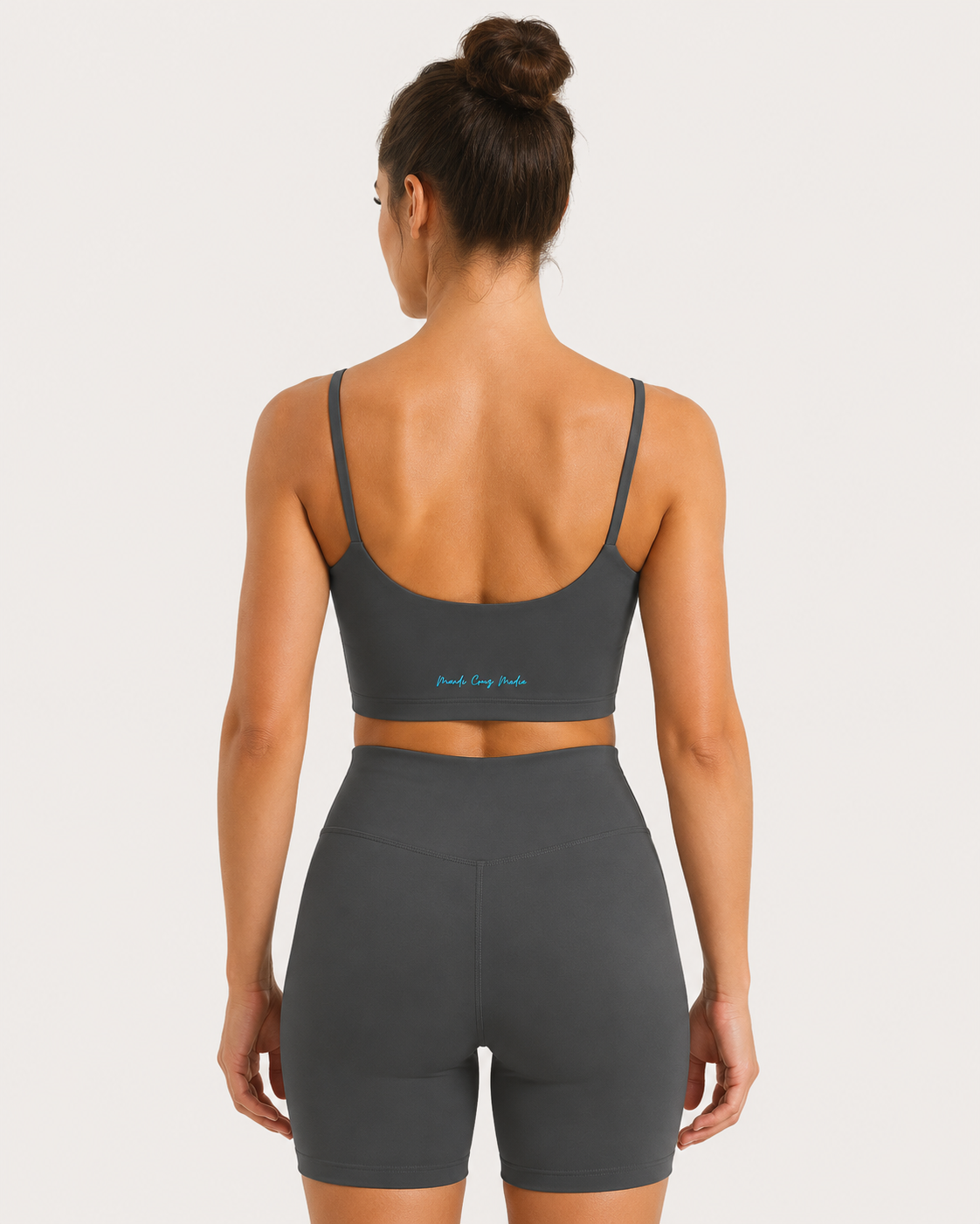 Back lifestyle view of the Neon THC Molecule Crop Tank showing the signature Mandi Cruz Media wordmark.