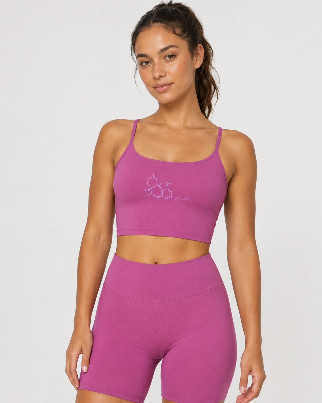 Woman wearing the Neon THC Molecule Crop Tank featuring the science-inspired THC molecular graphic on the front.