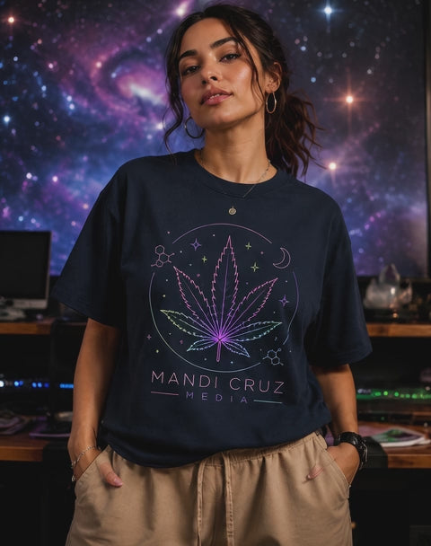 Model poses in a navy oversized Mandi Cruz Media T-shirt featuring a neon cannabis leaf, molecular dtails and celestial graphics agaist a galaxy background