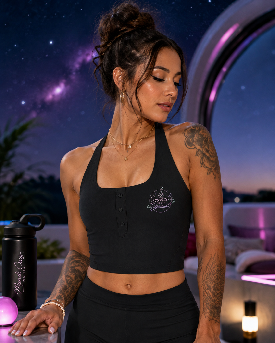 Model wearing the black Mandi Cruz Media Science Meets Stardust™ halter tank during a yoga-inspired lifestyle shoot.